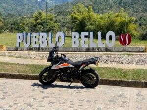 Motorcycle near Pueblo Bello sign. Valledupar, Colombia.