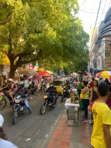 Busy street filled with people and vehicles. Valledupar, Colombia.